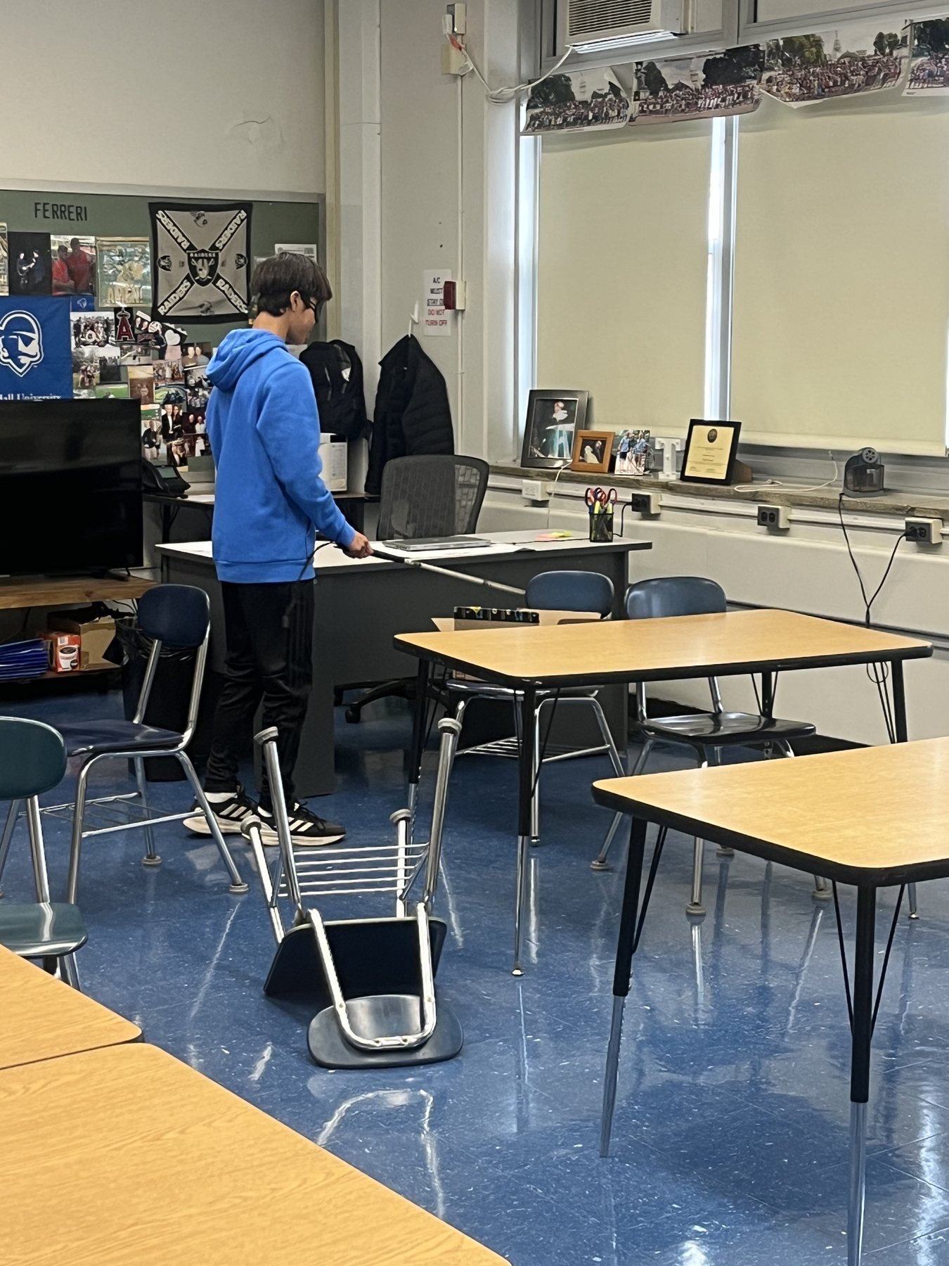 A student standing with a white cane during a lesson