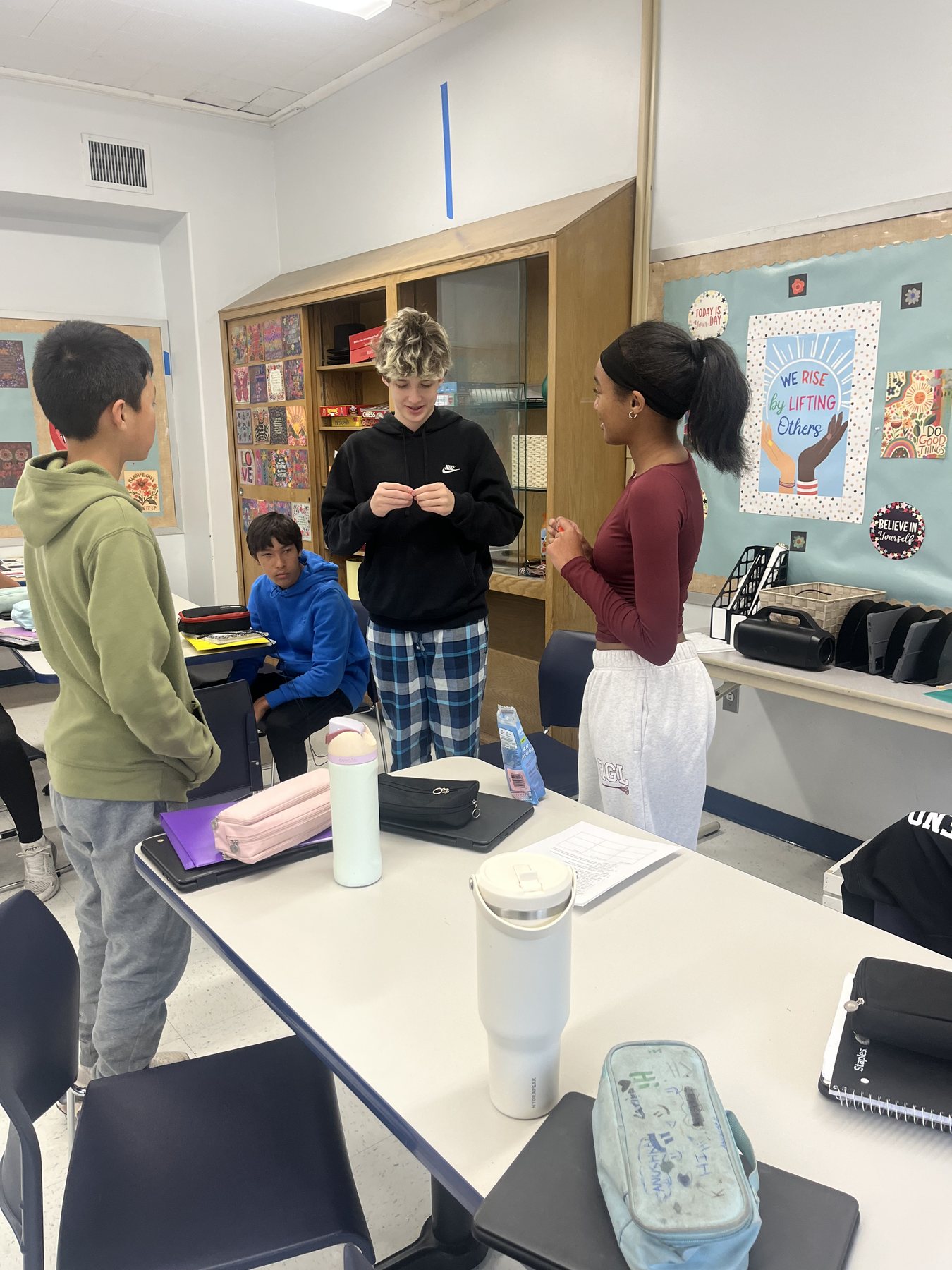 Students gathered around a desk during a BridgED session